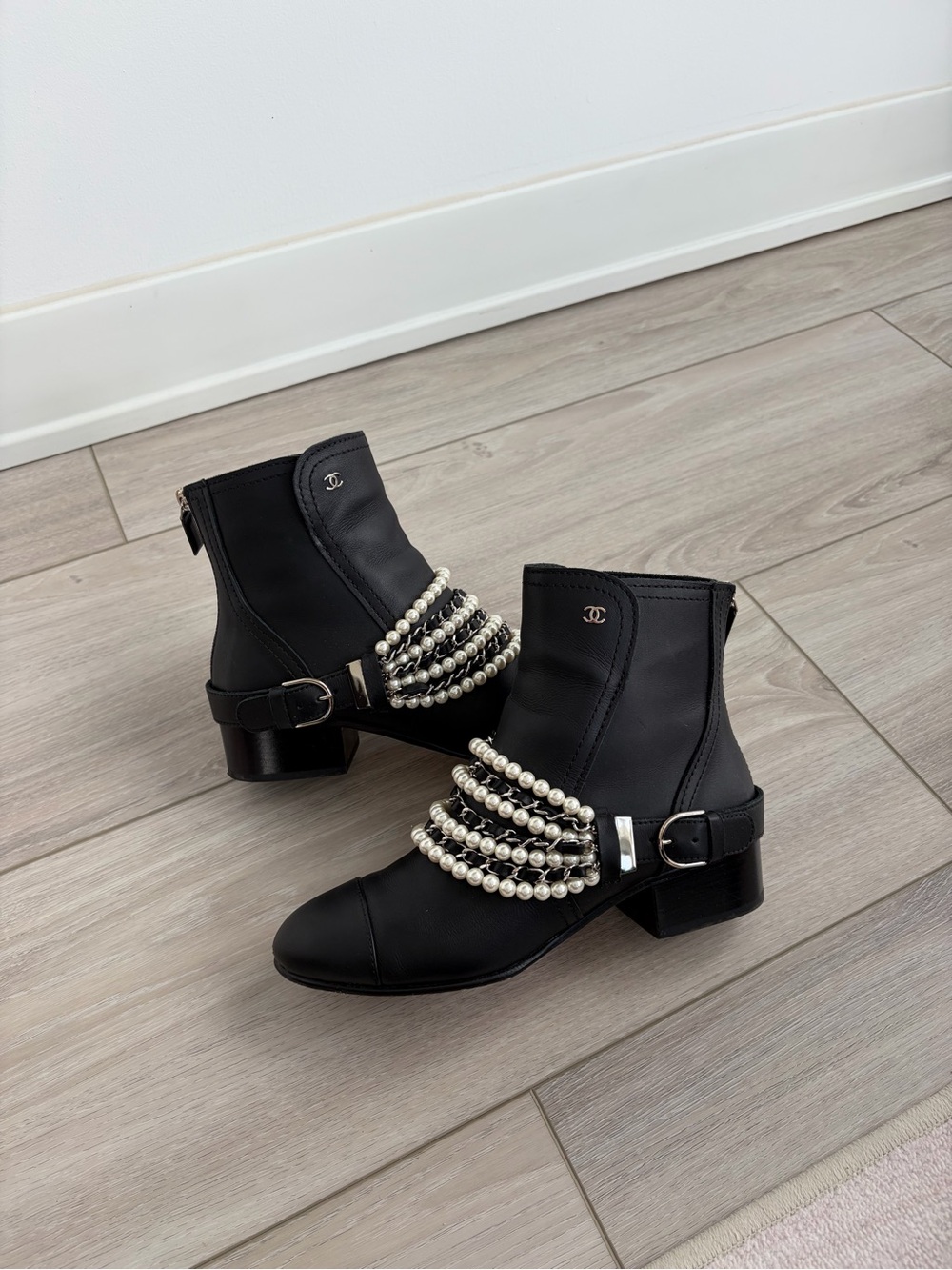 CHANEL Black Leather Ankle Boots with Pearl-Strap Detail
